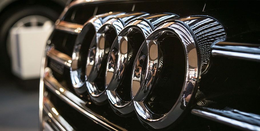close up of audi logo on front of car