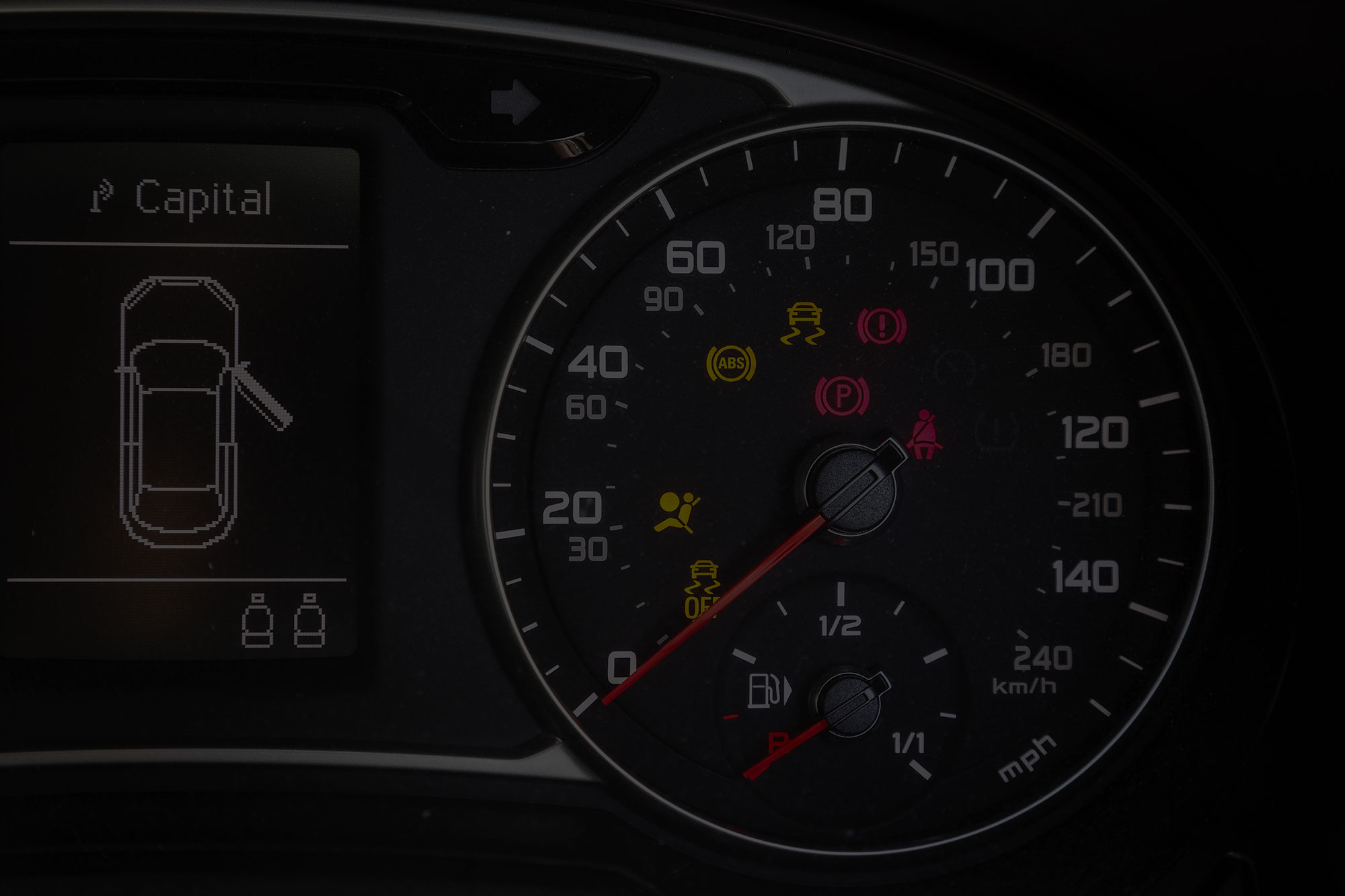 Car dashboard, showing car metrics and warning symbols