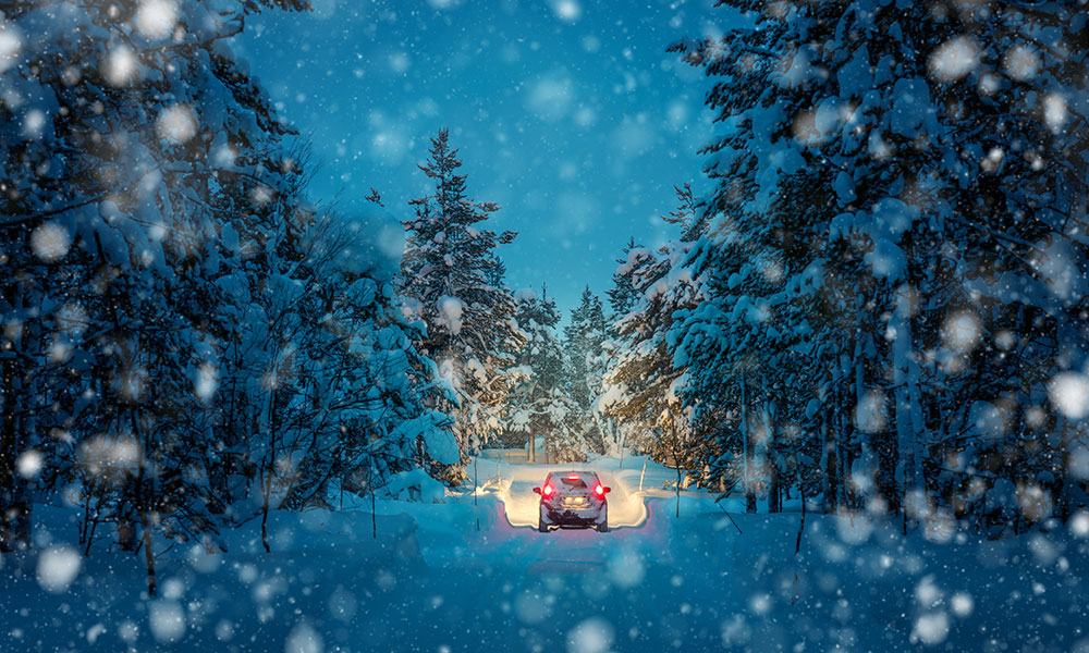 Car driving through a snowy landscape