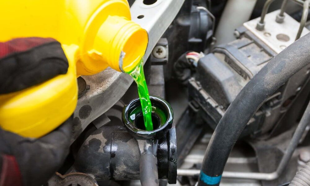 Engine coolant being poured into vehicle engine