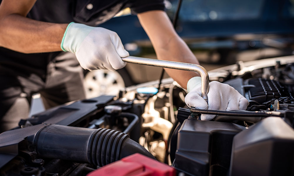 mechanic fixing a part in the inside of a car