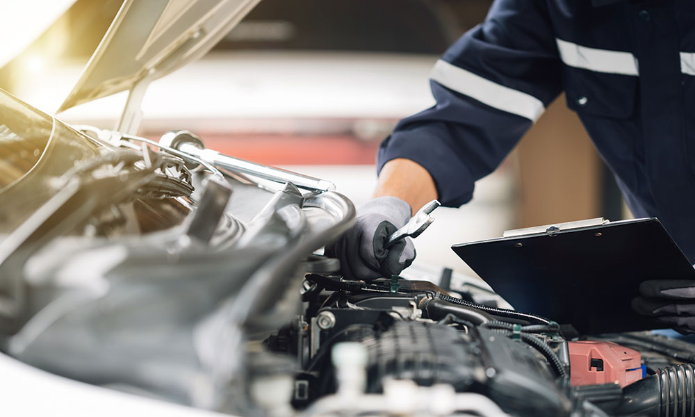 mechanic under the bonnet of car